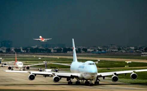 Planes taxiing and taking off at Ho Chi Minh Tan Son Nhat Airport.
