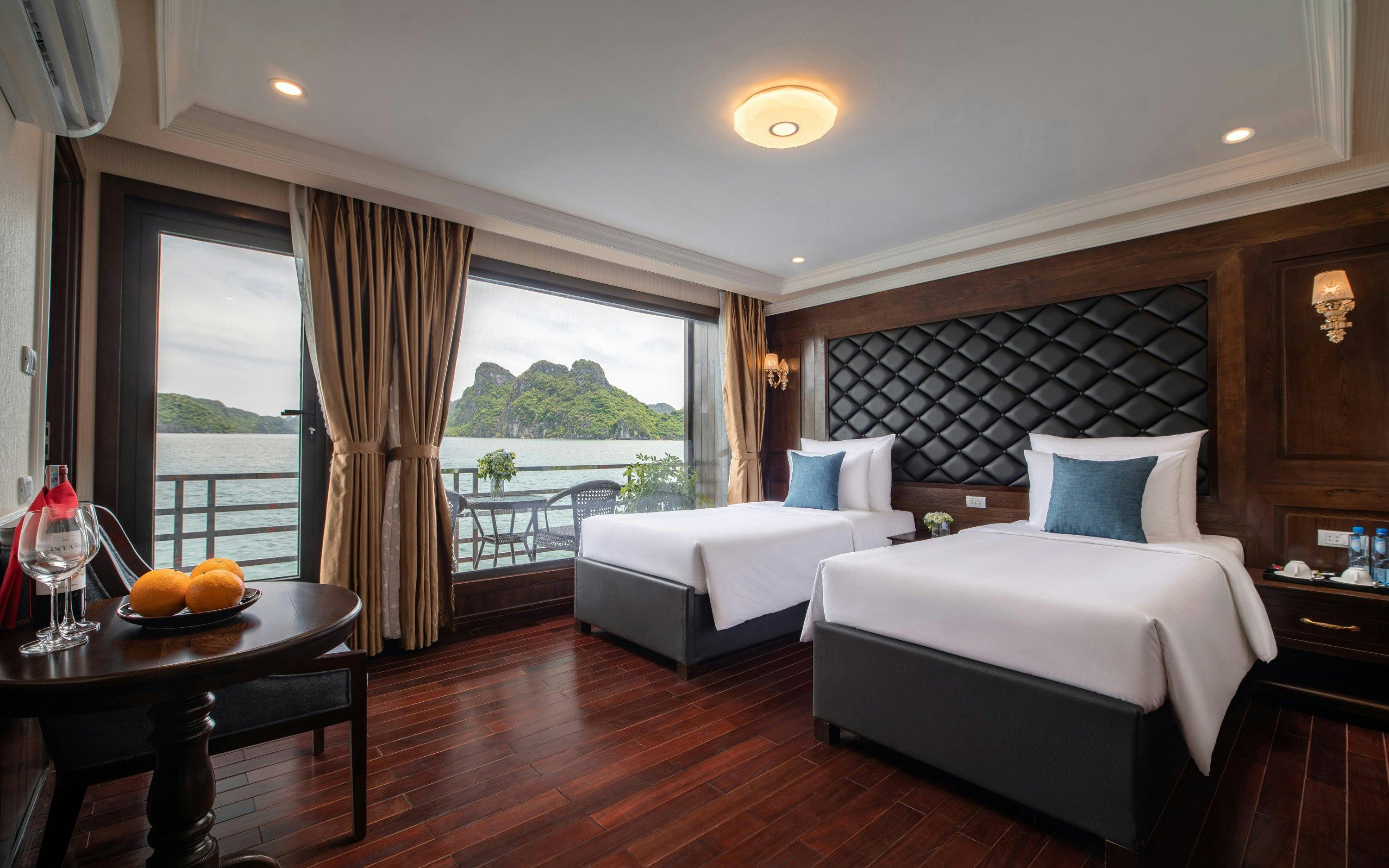 Cruise cabin with twin beds and ocean view in Lan Ha Bay.
