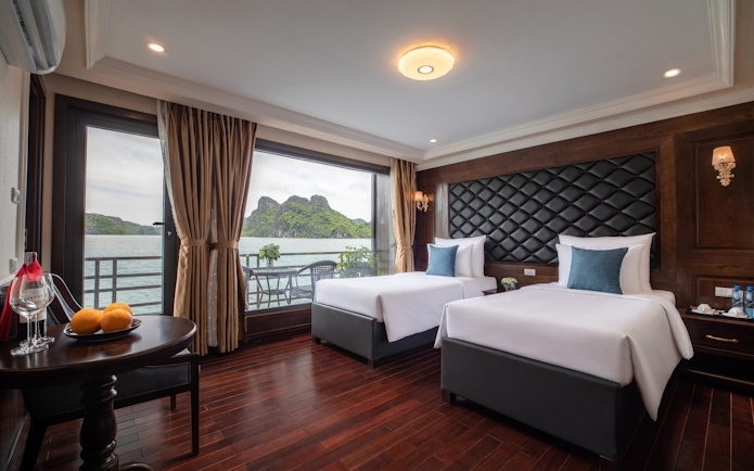 Cruise cabin with twin beds and ocean view in Lan Ha Bay.