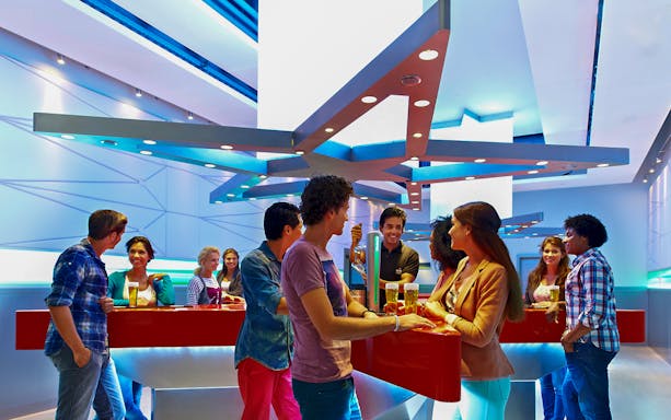 Visitors enjoying drinks at the Heineken Experience bar in Amsterdam.