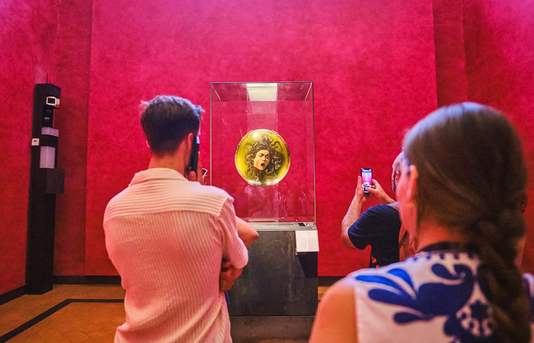 Vasari Corridor view with Uffizi Gallery artworks, Florence private tour.