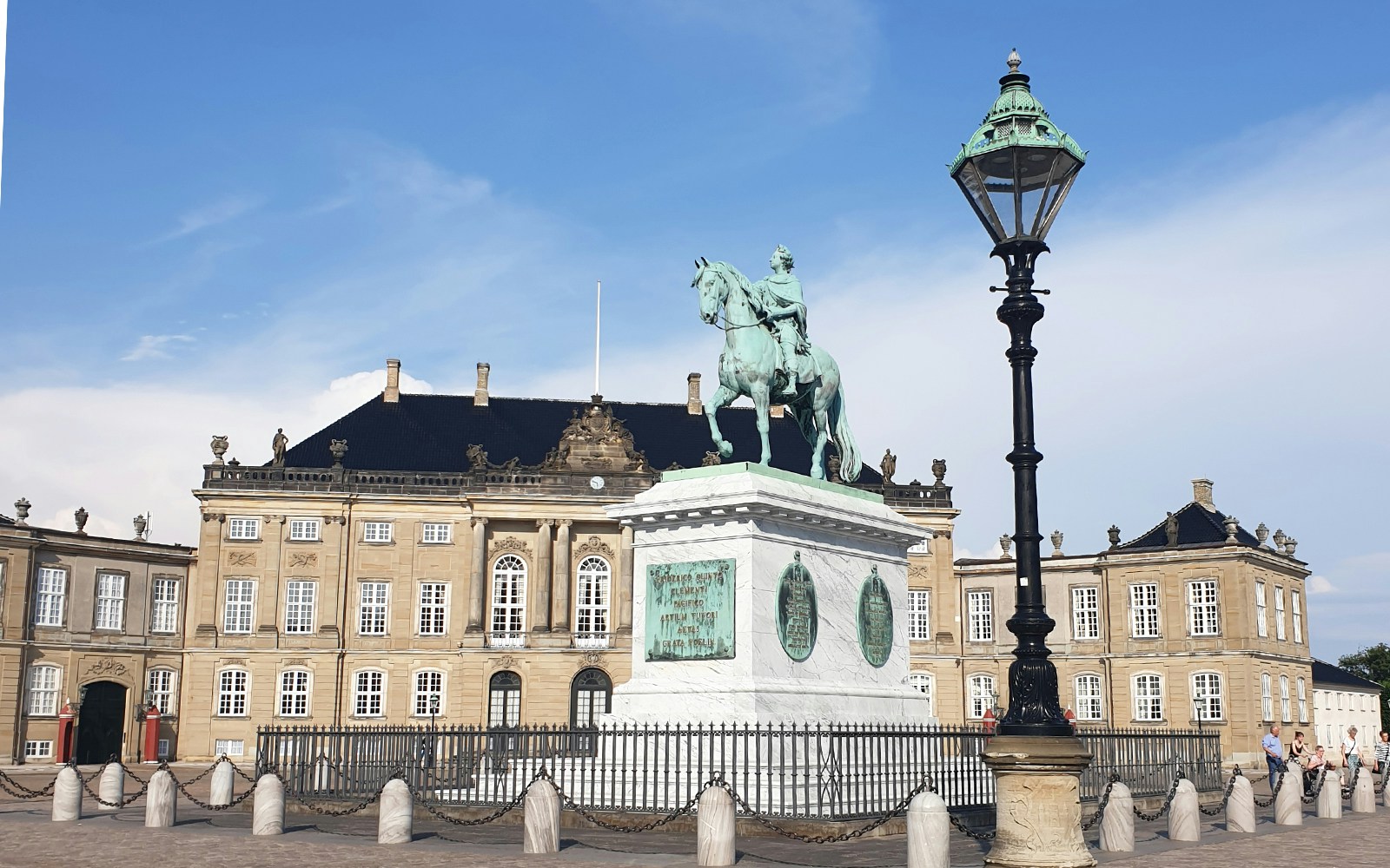 Amalienborg Palace courtyard with tourists participating in a mystery hunt, Copenhagen.