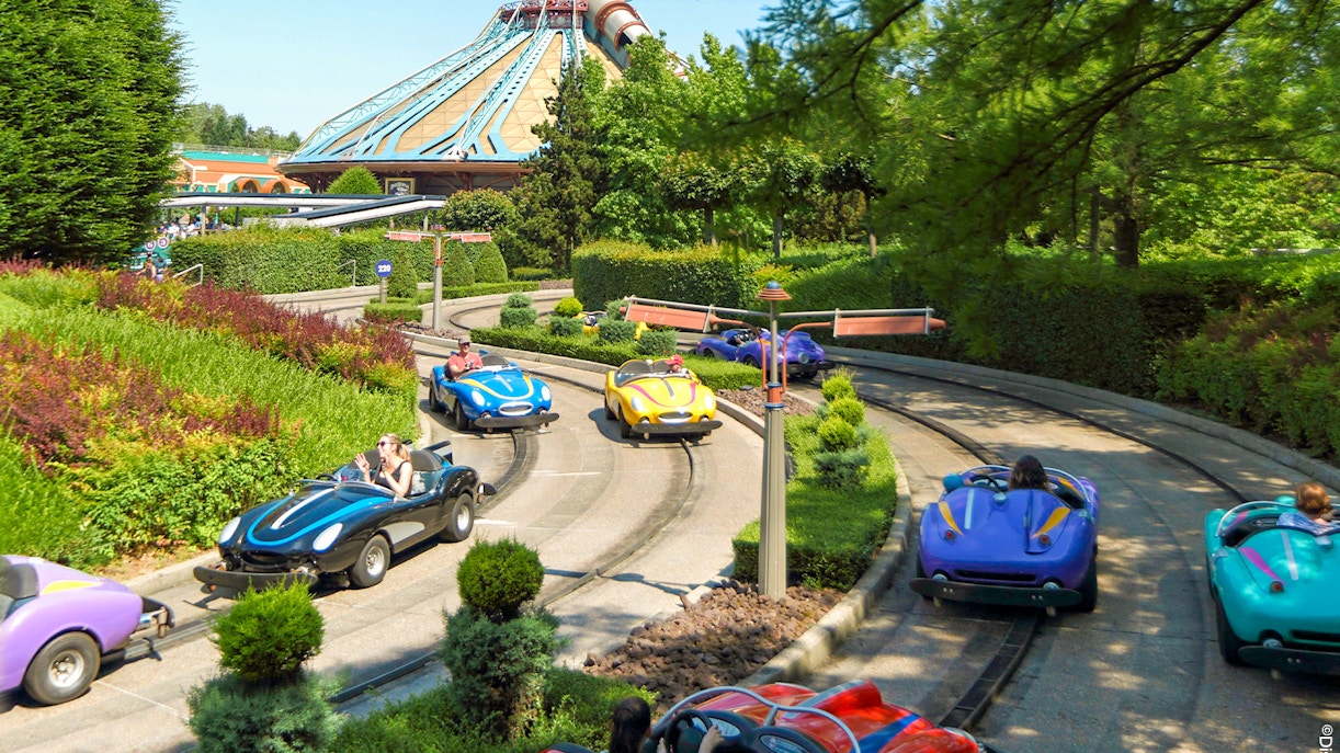 Autopia cars on track at Disneyland Paris with Space Mountain in the background.