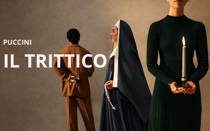 Puccini's Il Trittico characters in period costumes, one holding a candle.