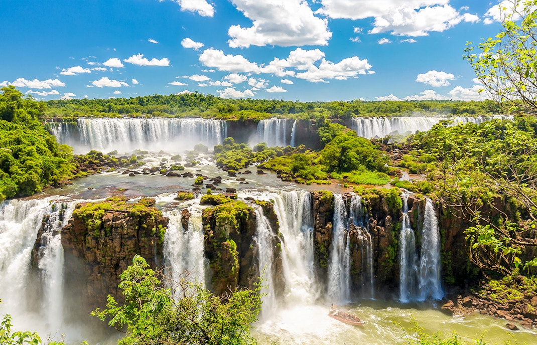 Iguazú Falls cascading over lush cliffs in Argentina.