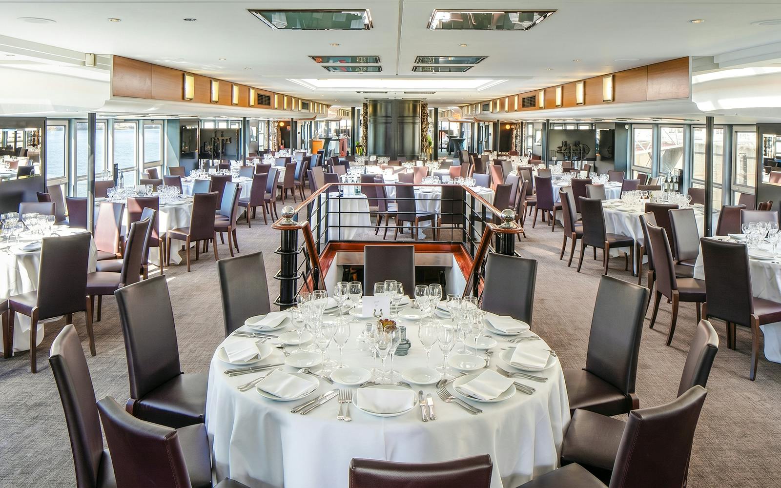 Elegant dining setup on a Paris Bastille Day dinner cruise ship.