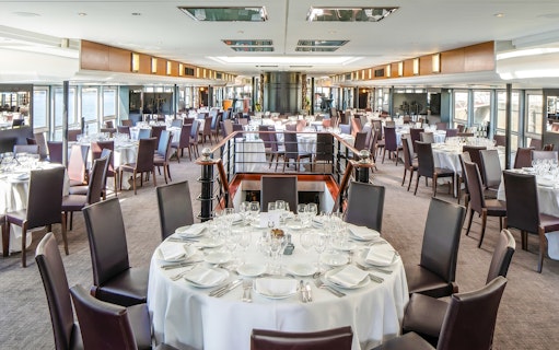 Elegant dining setup on a Paris Bastille Day dinner cruise ship.