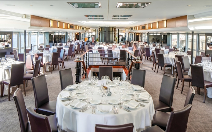 Elegant dining setup on a Paris Bastille Day dinner cruise ship.