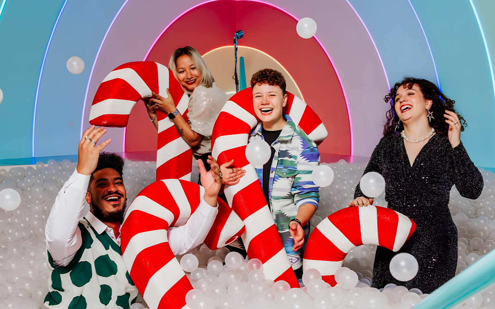 Visitors enjoying candy cane props at The Upside Down Amsterdam exhibit.