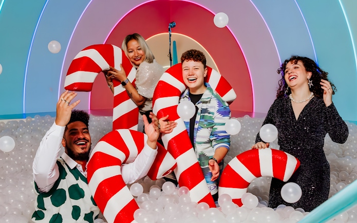 Visitors enjoying candy cane props at The Upside Down Amsterdam exhibit.