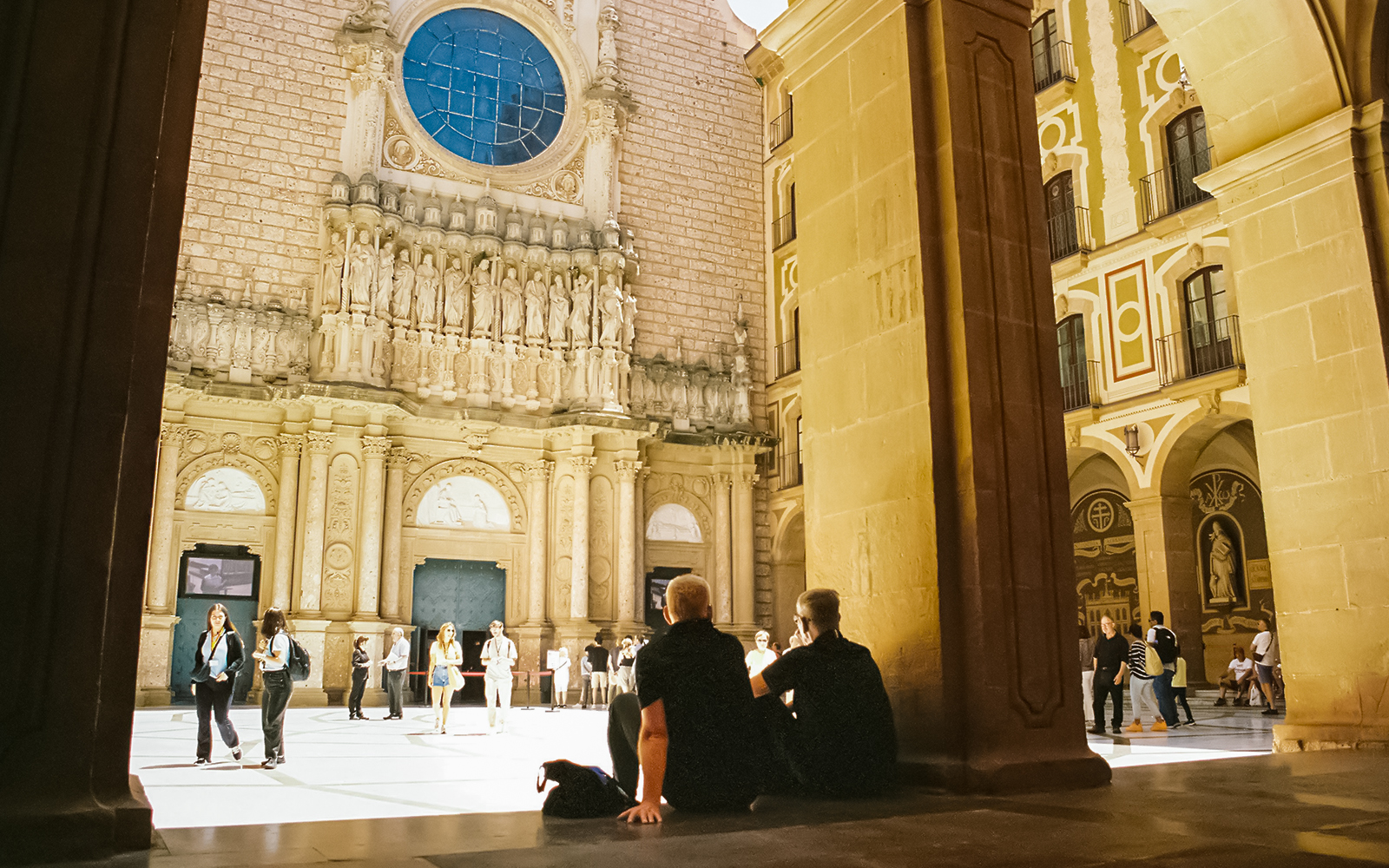 Visitors exploring the courtyard of Abbey of Montserrat, Spain.