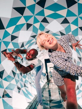 Visitors enjoying optical illusions at Paradox Museum, France.