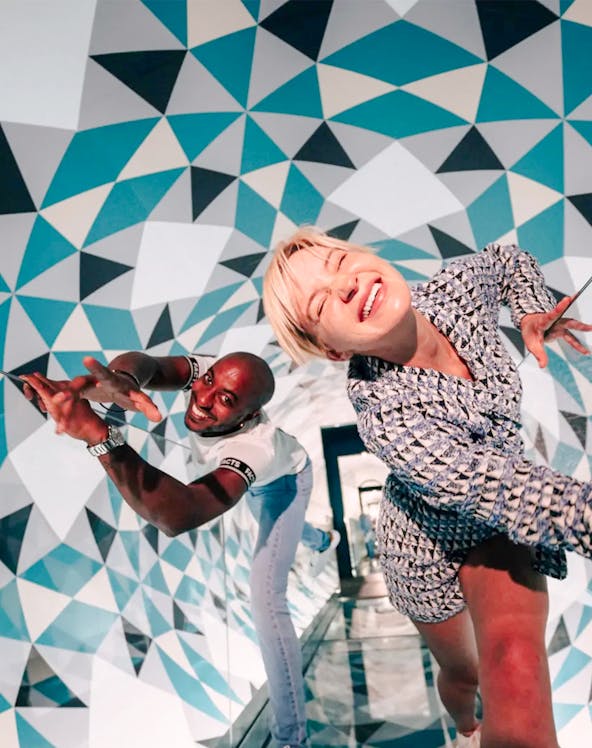 Visitors enjoying optical illusions at Paradox Museum, France.