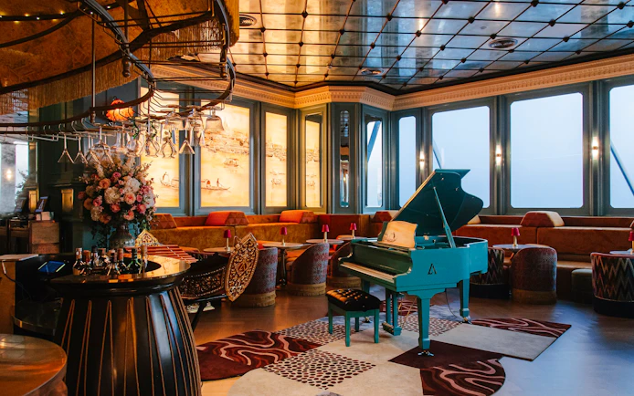 Siam Societies lounge with blue piano on the 58th floor of Akara Sky Hanuman in Bangkok.