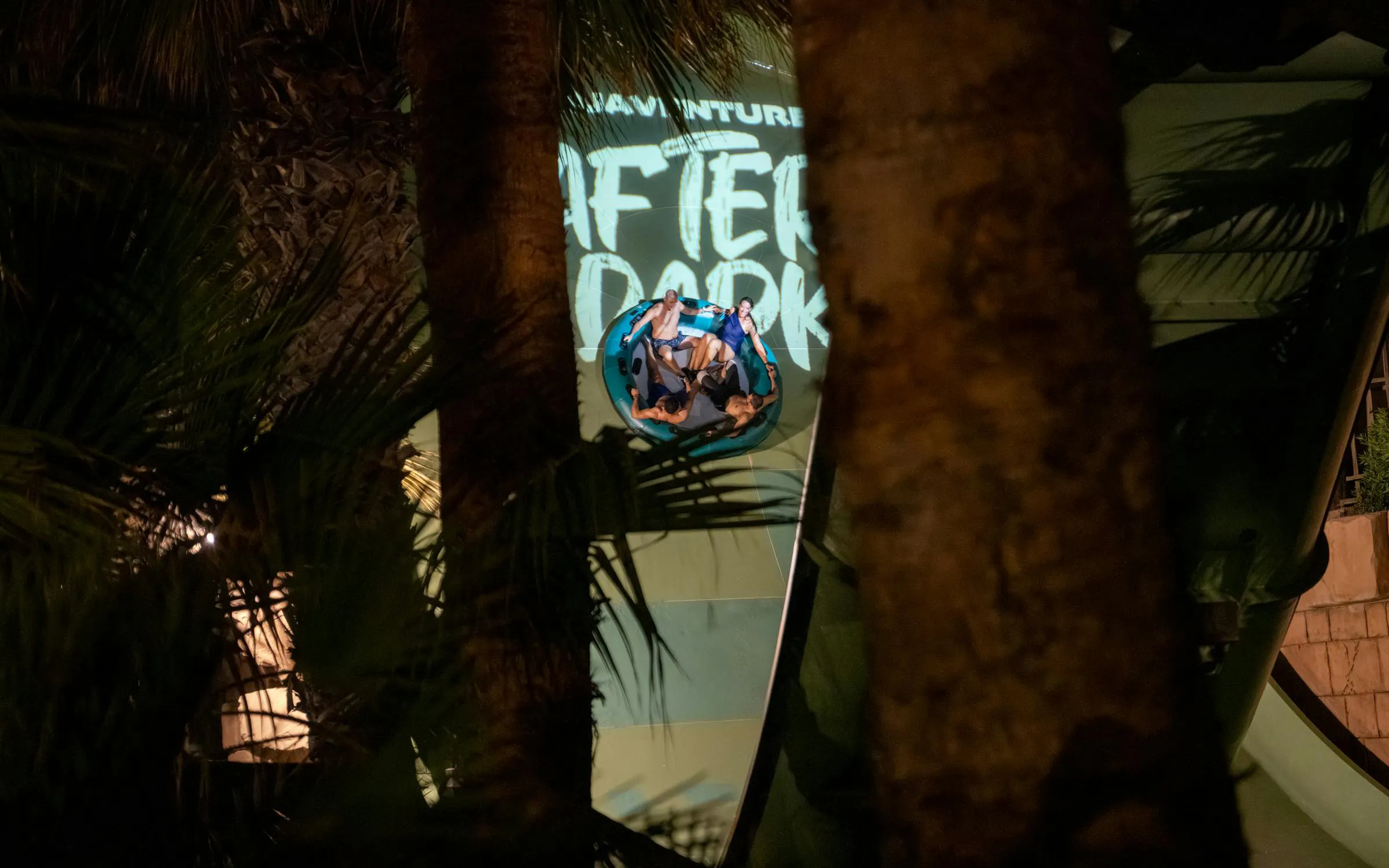 Group enjoying a nighttime water ride at Aquaventure After Dark.