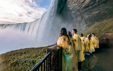 Visitors in yellow ponchos at Niagara Falls viewpoint.