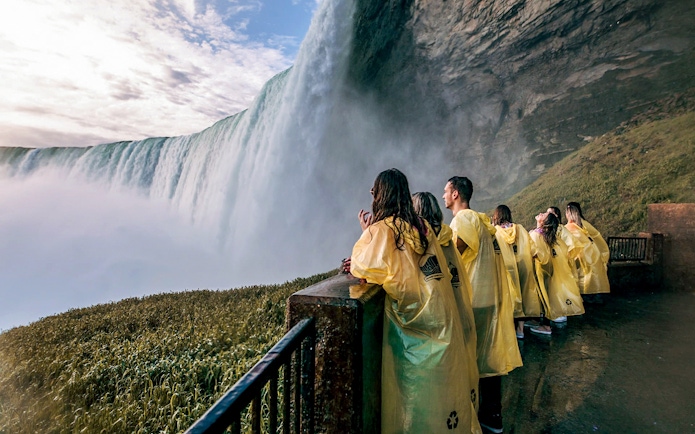 Visitors in yellow ponchos at Niagara Falls viewpoint.