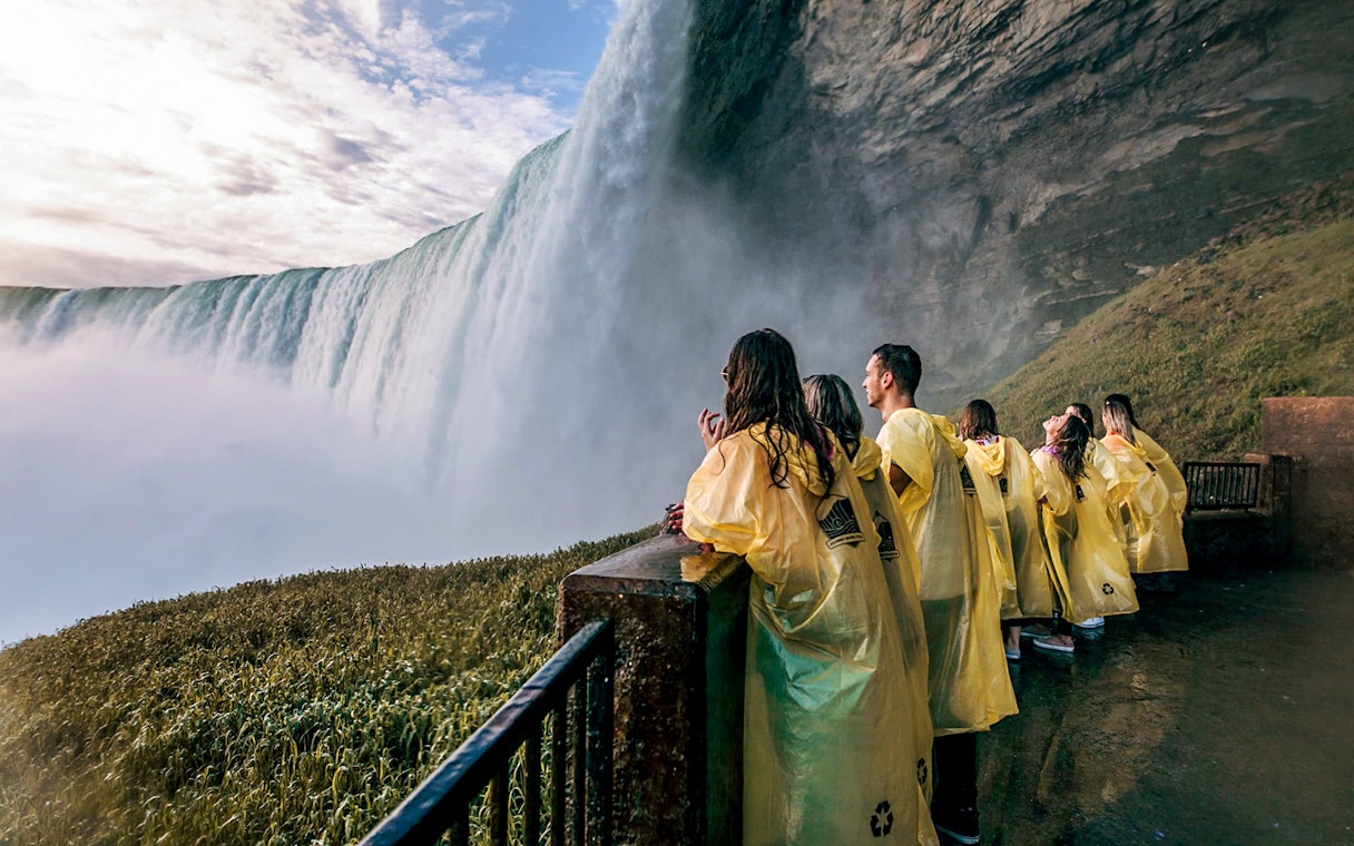 Visitors in yellow ponchos at Niagara Falls viewpoint.