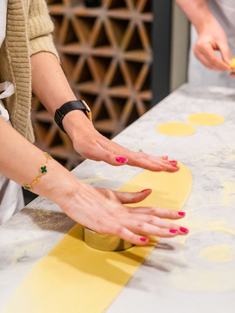 Hands rolling pasta dough in a Florence pasta-making class.