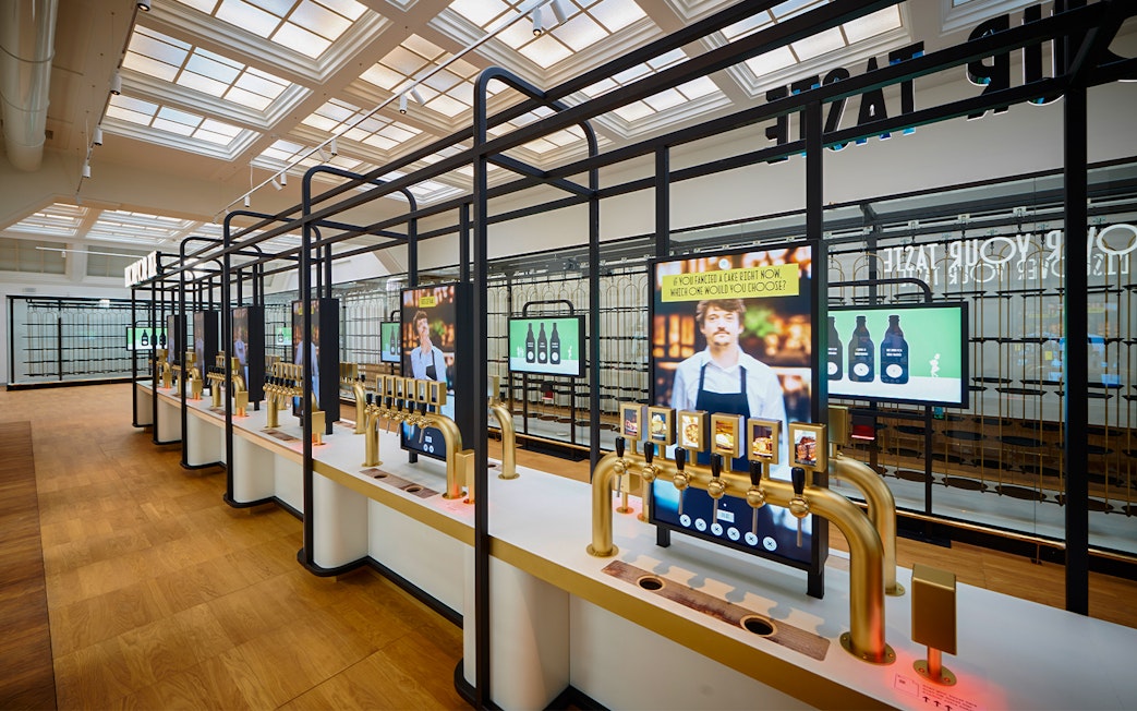 Beer tasting taps and digital screens inside Belgian Beer World, Brussels.