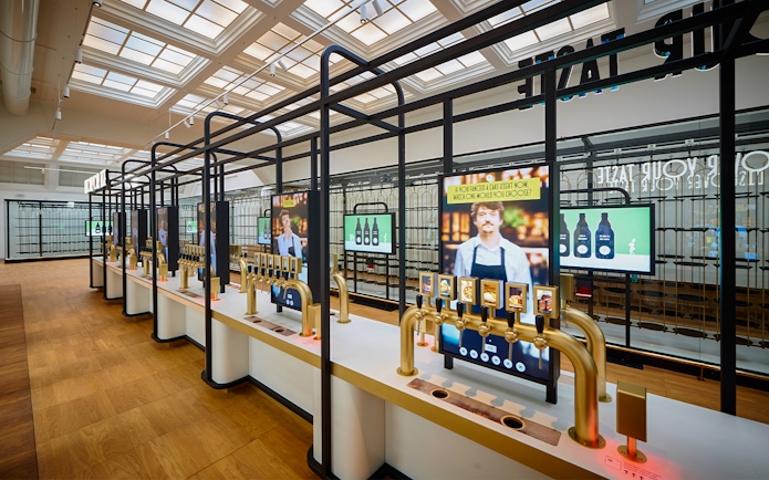 Beer tasting taps and digital screens inside Belgian Beer World, Brussels.