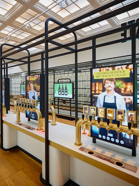 Beer tasting taps and digital screens inside Belgian Beer World, Brussels.