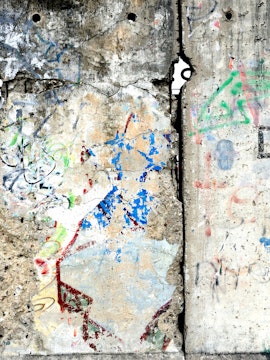 Berlin Wall section with colorful graffiti, showcasing historical significance in Berlin, Germany.