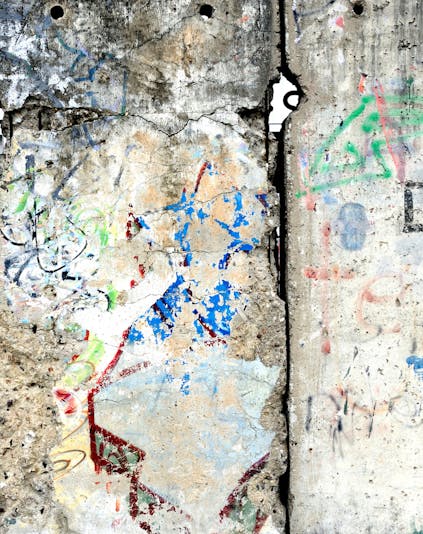Berlin Wall section with colorful graffiti, showcasing historical significance in Berlin, Germany.
