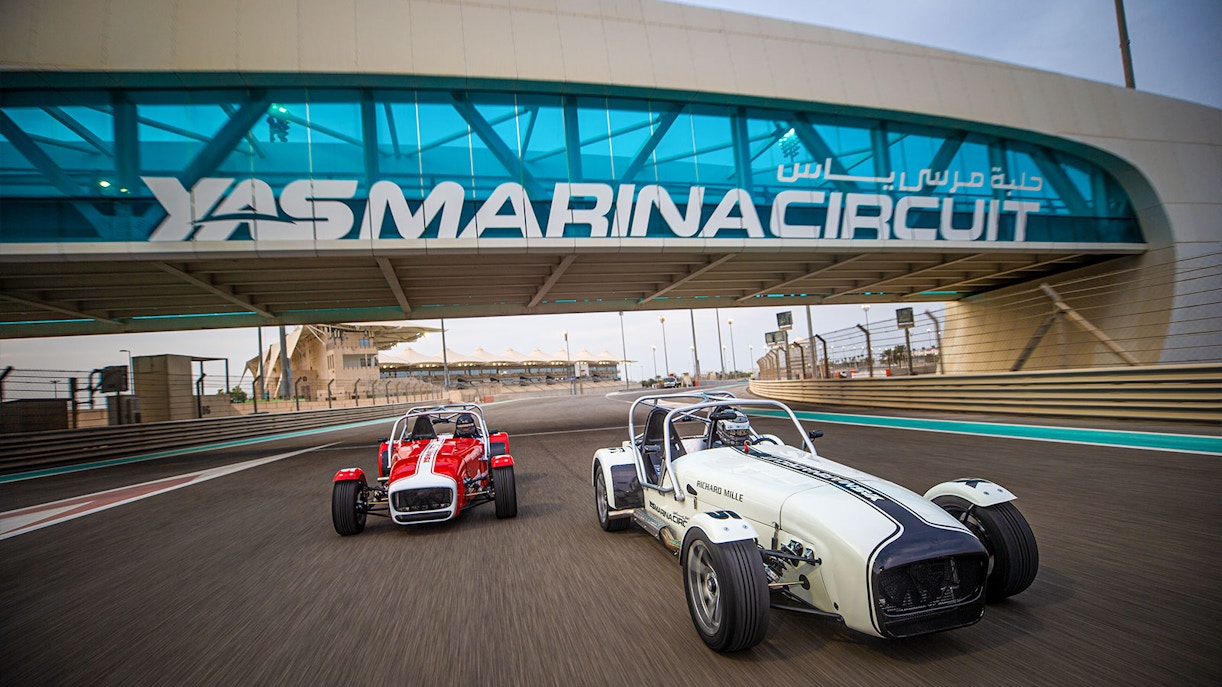Caterham Seven cars driving on Yas Marina Circuit in Dubai.