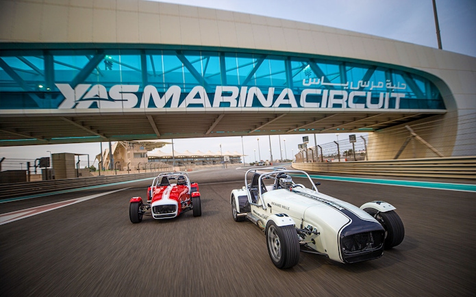 Caterham Seven cars driving on Yas Marina Circuit in Dubai.