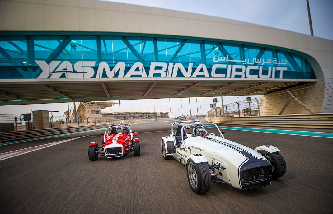 Caterham Seven cars driving on Yas Marina Circuit in Dubai.