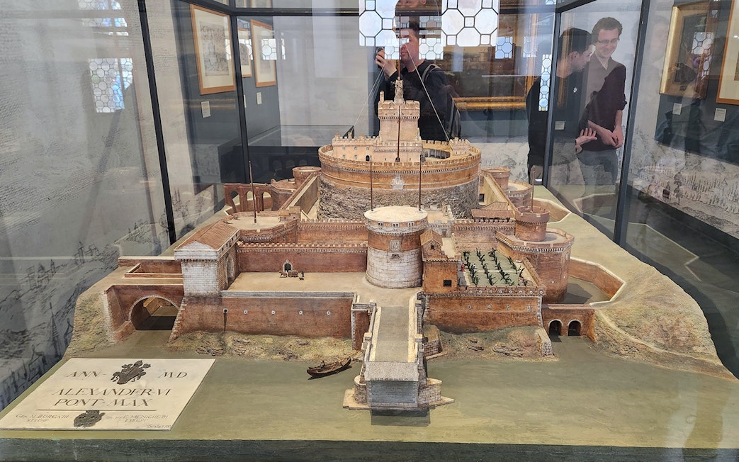 Miniature model of Castel Sant'Angelo in Rome, showcasing detailed architecture and surrounding landscape.