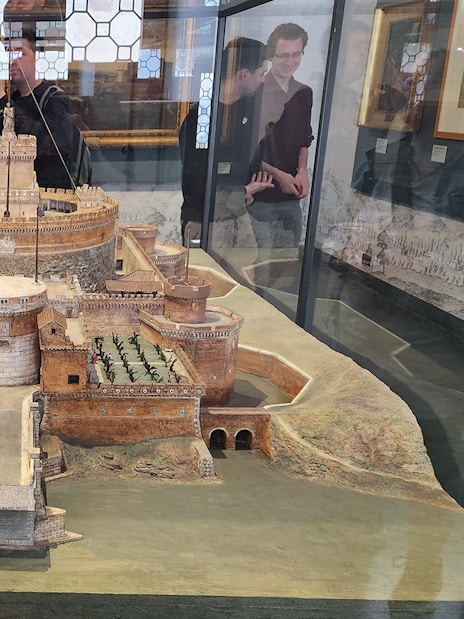 Miniature model of Castel Sant'Angelo in Rome, showcasing detailed architecture and surrounding landscape.