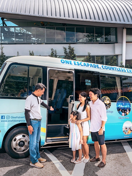 Family boarding tour bus at Singapore cable car station.
