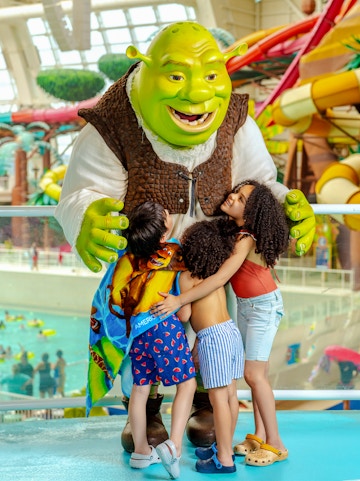 Shrek hugging children at American Dream water park.