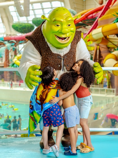 Shrek hugging children at American Dream water park.