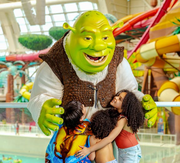 Shrek hugging children at American Dream water park.