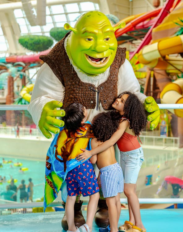 Shrek hugging children at American Dream water park.