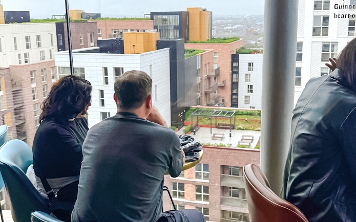 People enjoying drinks with city view at Gravity Bar inside Guinness Storehouse.