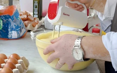 Mixing batter for pasta in a Florence cooking class with Tuscan wine.