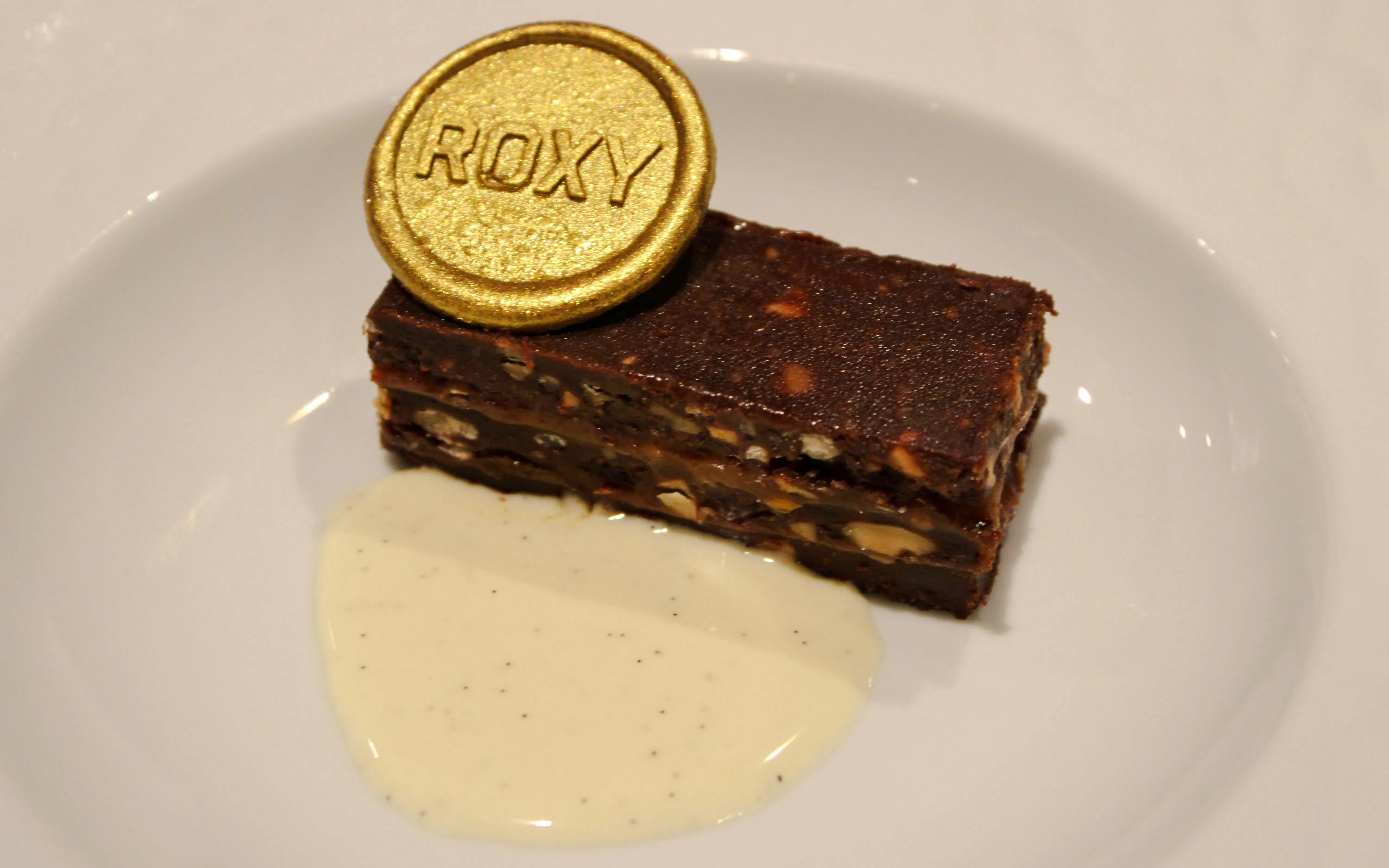 Chocolate dessert with nuts and gold Roxy coin at Roxy Dinner Show, Rio de Janeiro.