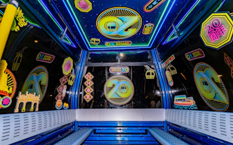 Interiors of Ngong Ping 360 cable car with colorful neon decorations on Lantau Island.