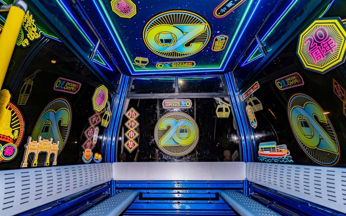 Interiors of Ngong Ping 360 cable car with colorful neon decorations on Lantau Island.