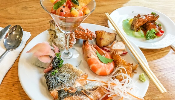 Seafood platter with shrimp, salmon, and crab on Santorini cruise lunch.