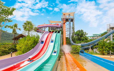 Water slides at Ramayana Water Park with people enjoying rides.