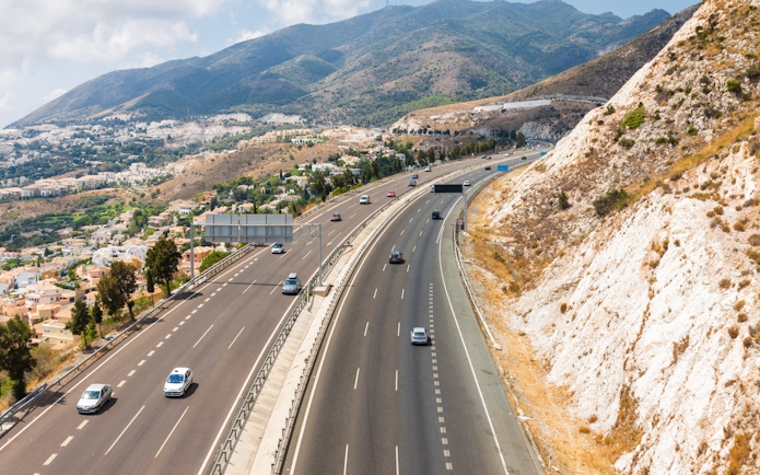 Aerial view of highway and mountains from Benalmadena cable car, Malaga, Spain.