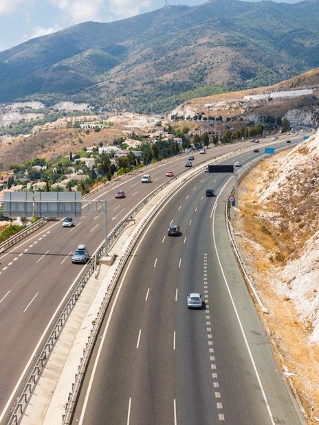 Aerial view of highway and mountains from Benalmadena cable car, Malaga, Spain.