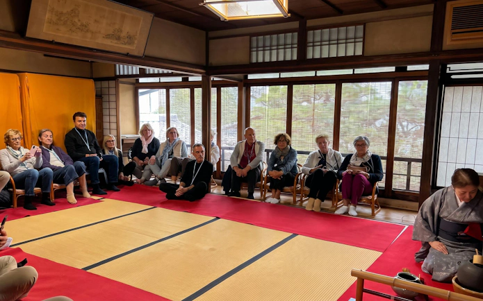 Guests seated in a traditional tea room in Kyoto during a tea ceremony.