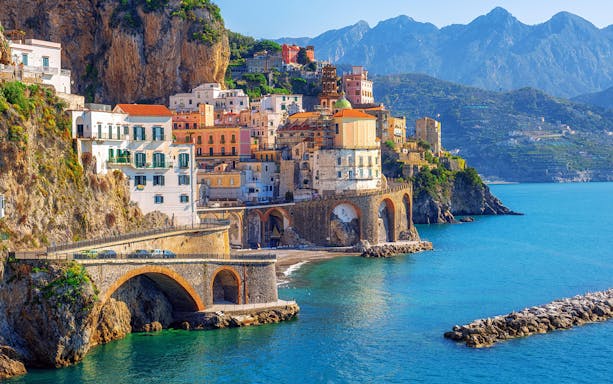Positano coastal view with colorful cliffside buildings and sea, part of a full-day guided tour.