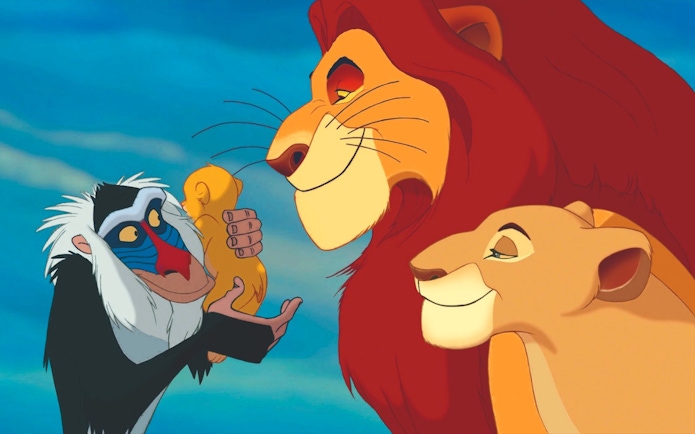 Rafiki holding baby Simba with Mufasa and Sarabi in the Lion King scene.